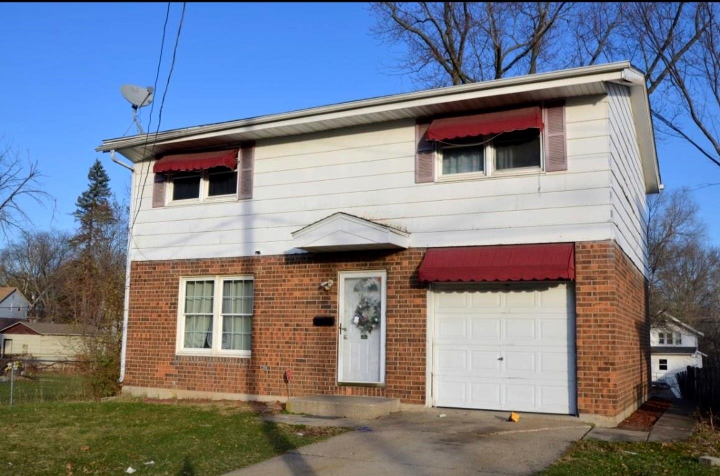 a view of a house with a small backyard