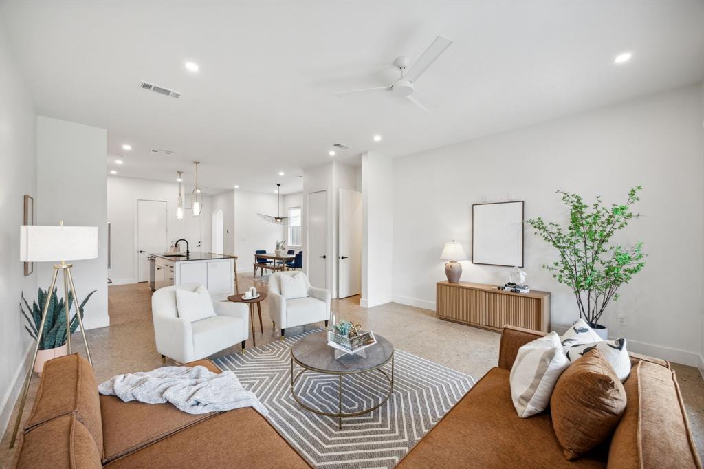 a living room with furniture and a potted plant