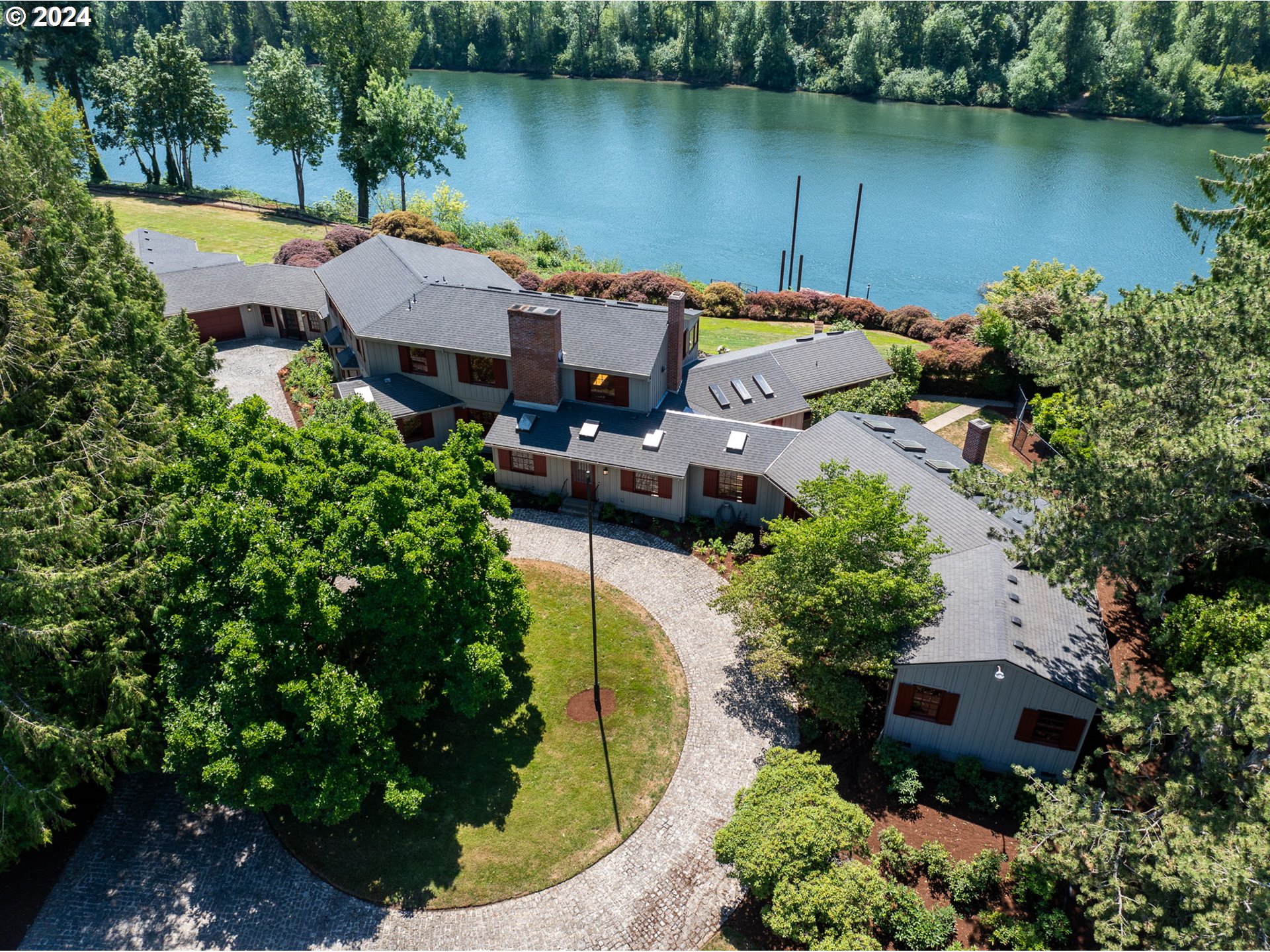 an aerial view of a house with swimming pool and outdoor space