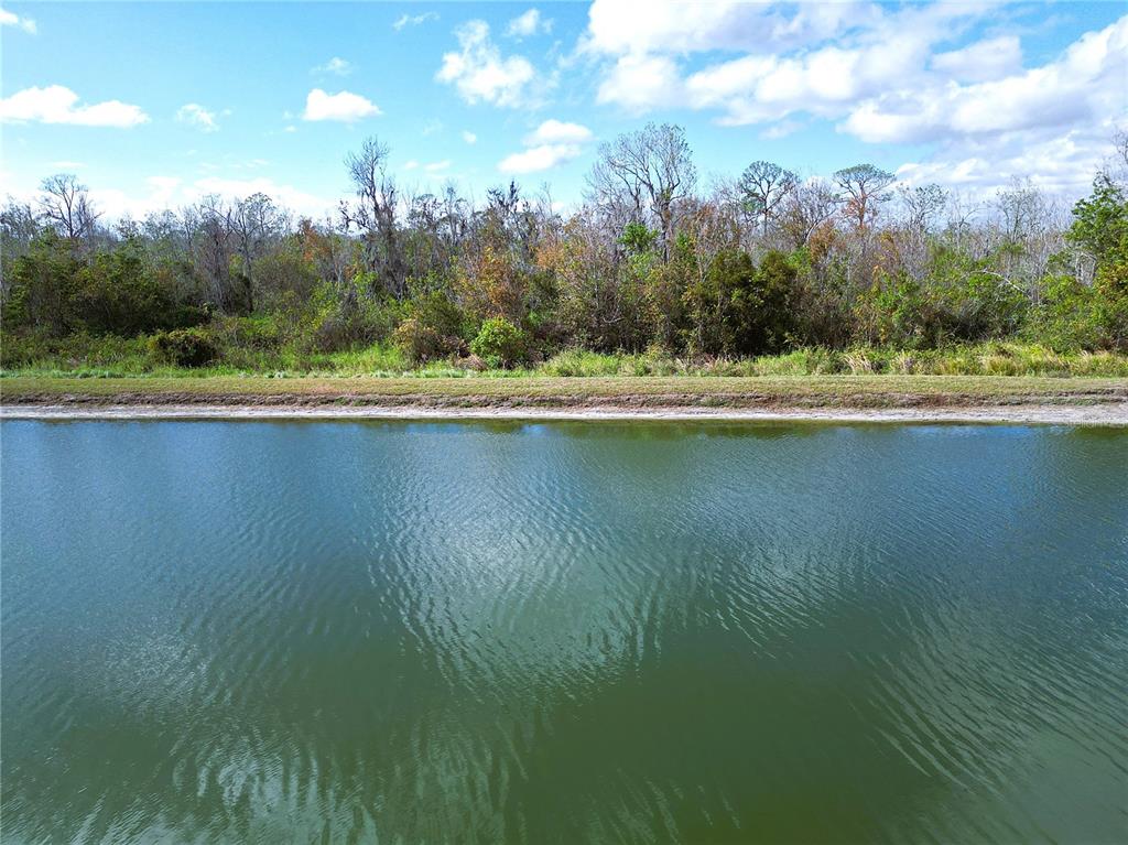 a view of a lake with a yard