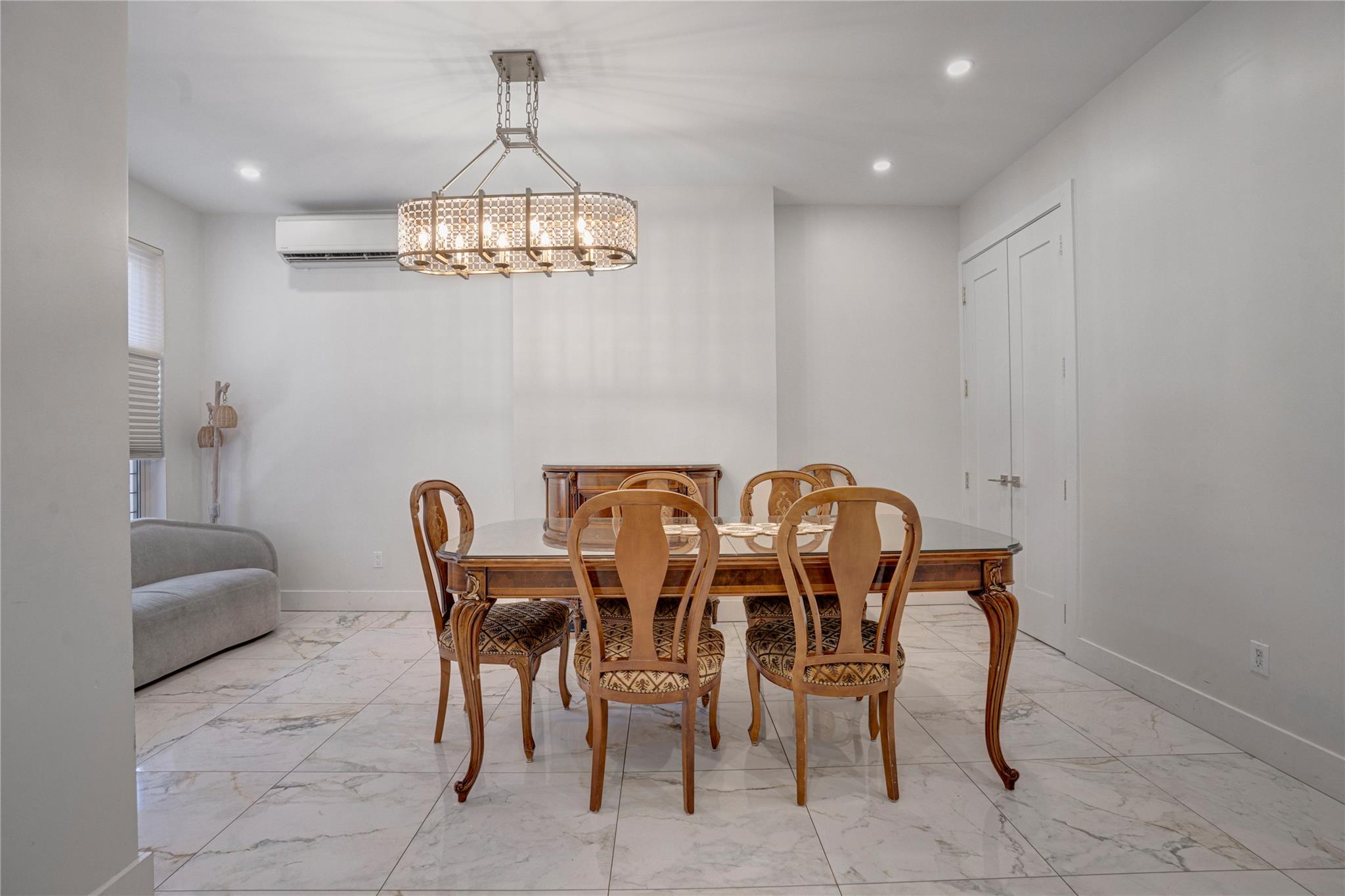 Dining room with an inviting chandelier and a wall unit AC