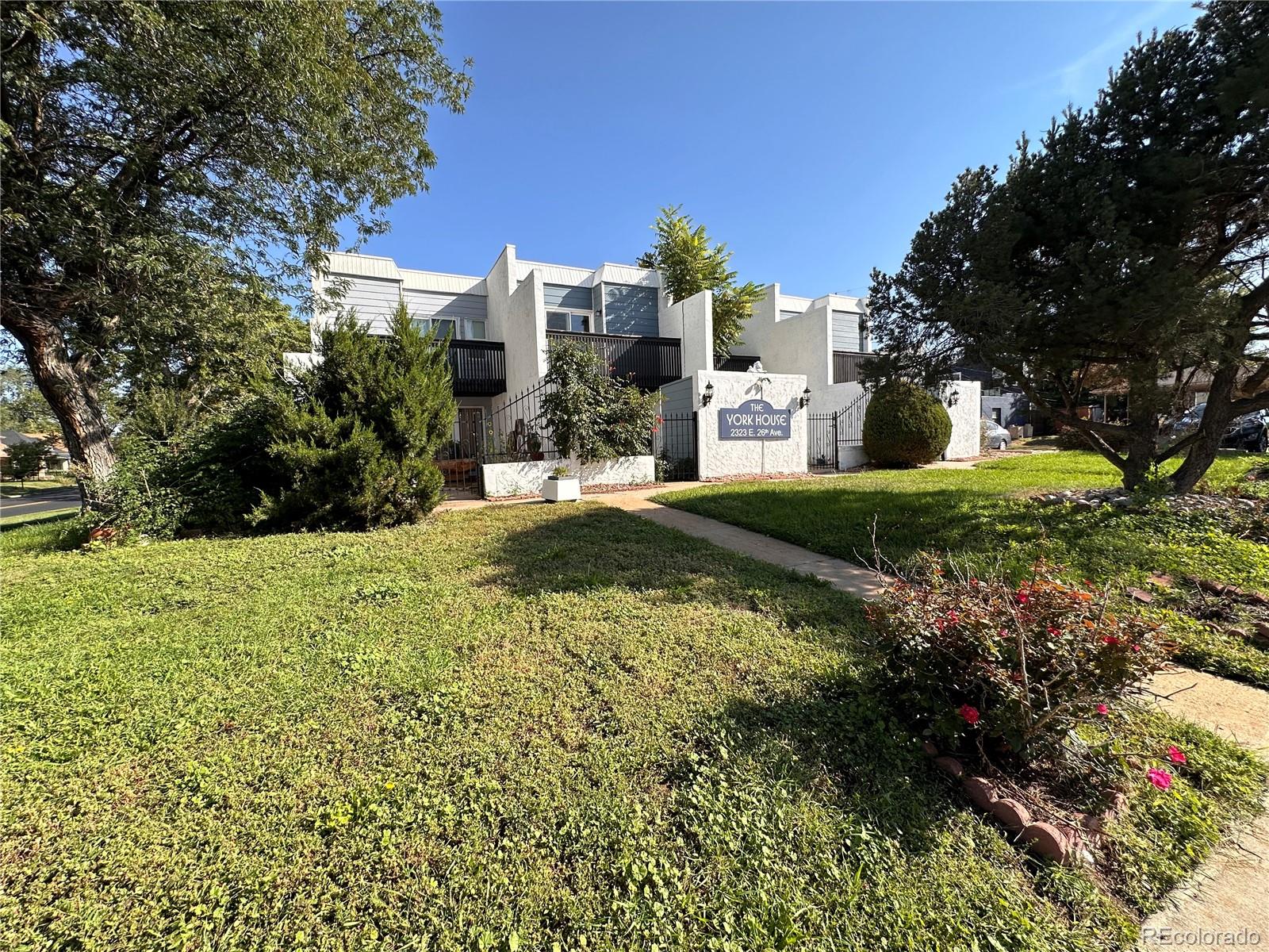 a view of a house with a yard and plants