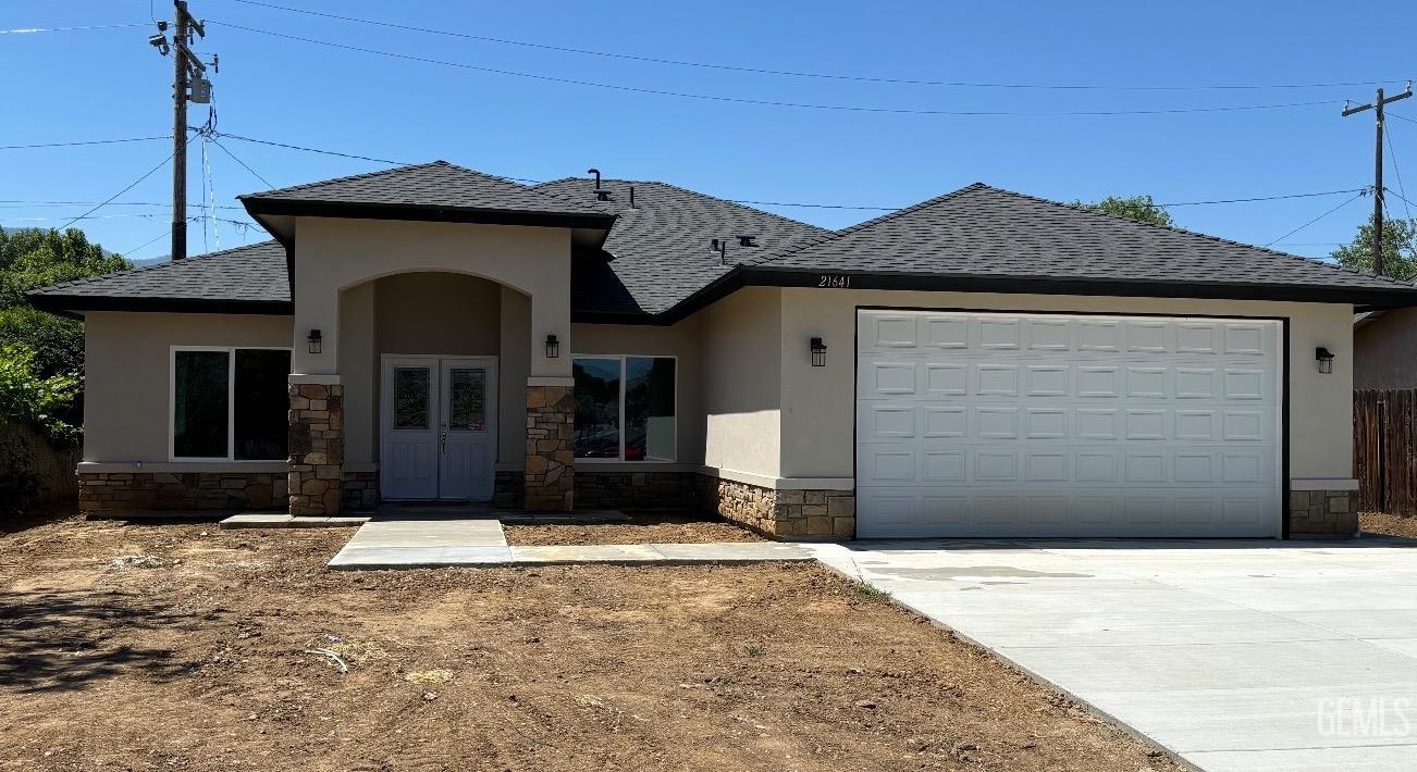 a front view of a house with garage