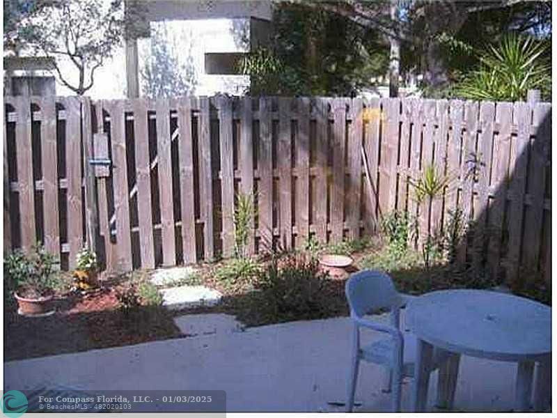 a view of a wooden chairs in a backyard