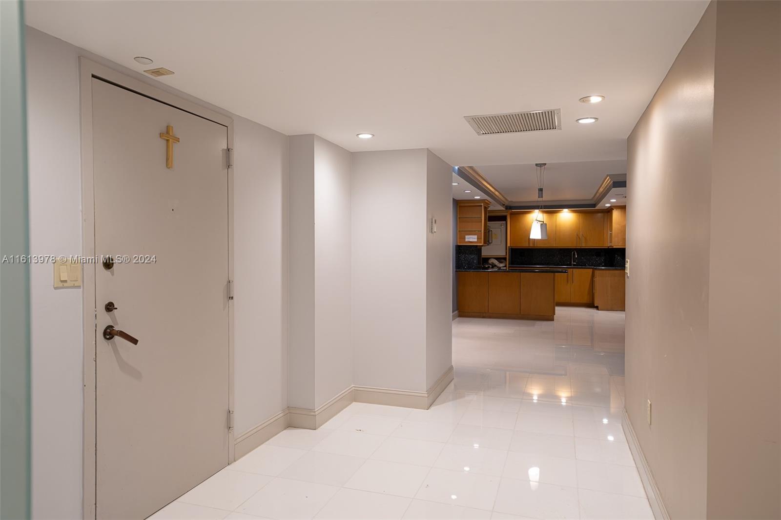 a view of a hallway with a kitchen