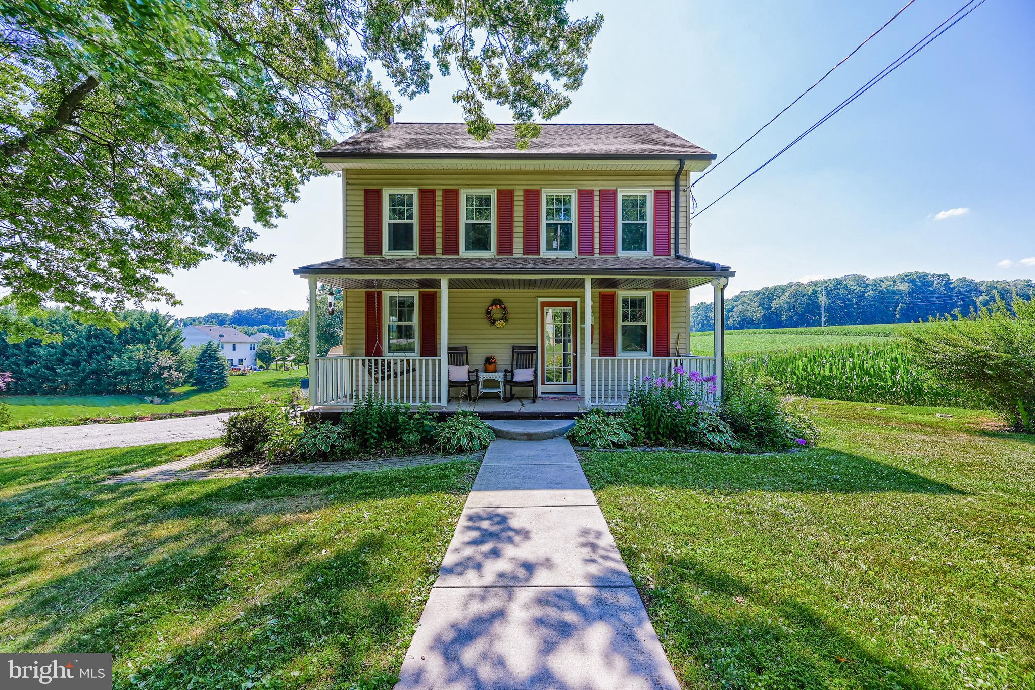 a front view of house with yard and green space