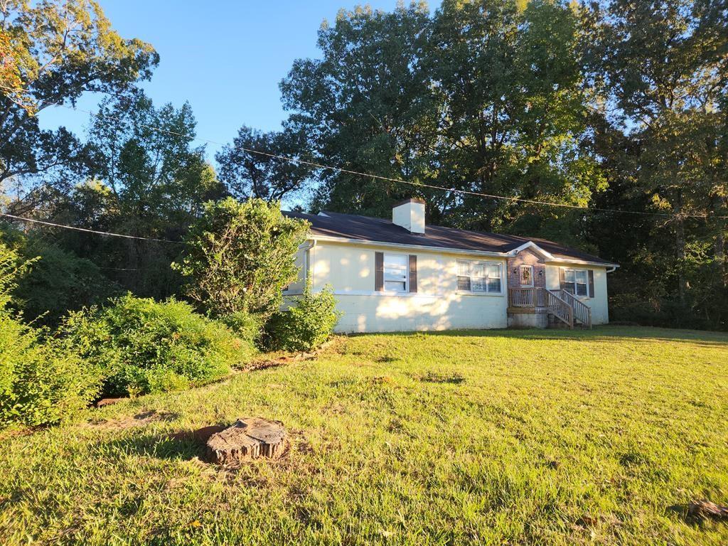 a front view of house with yard and trees around