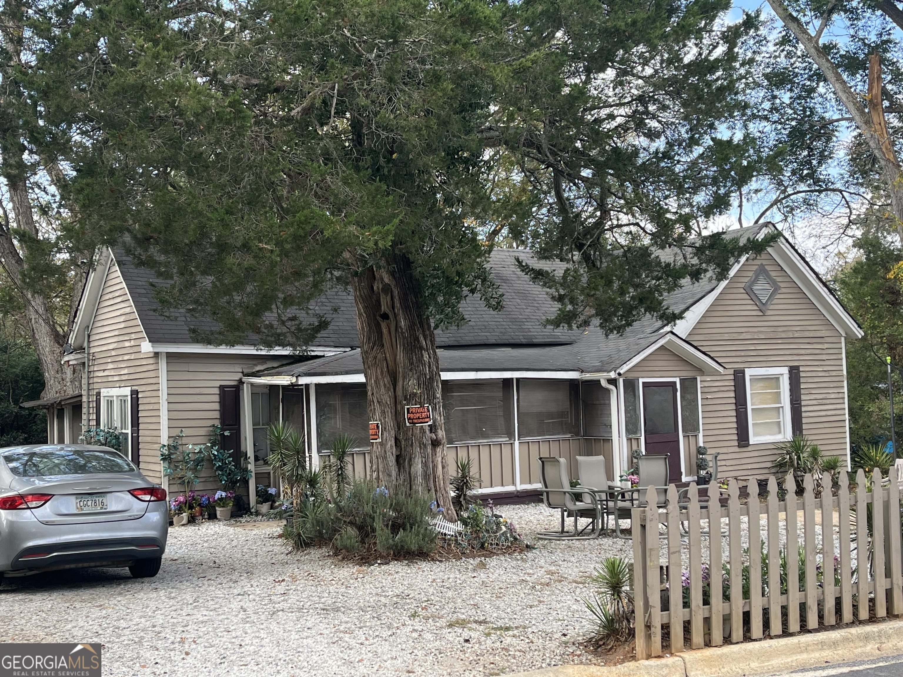 a front view of a house with yard and seating space