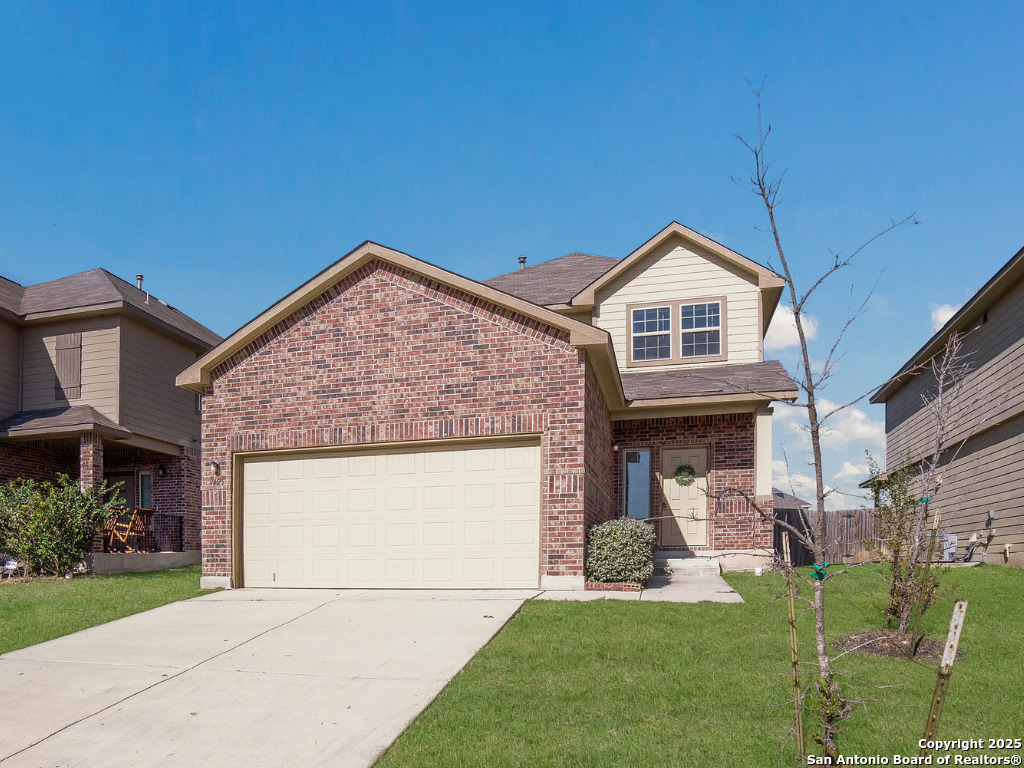 a front view of a house with a yard and garage