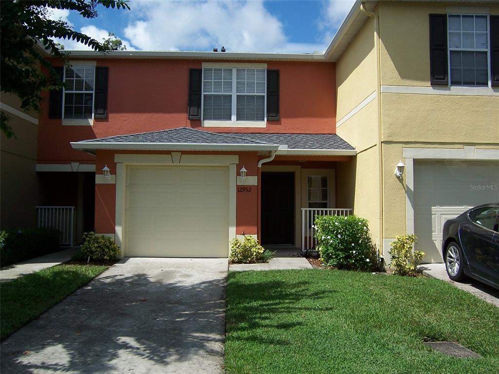 a front view of a house with a yard and garage