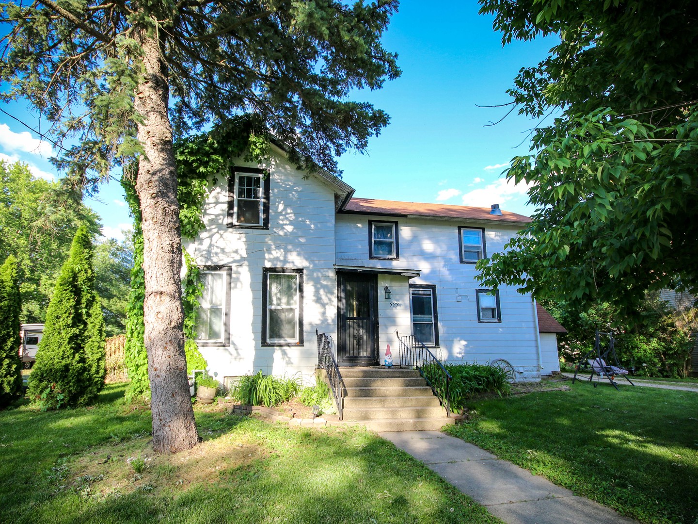 a front view of a house with a yard and porch