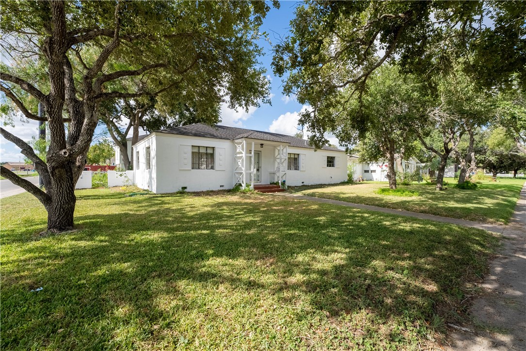 a front view of house with yard and green space