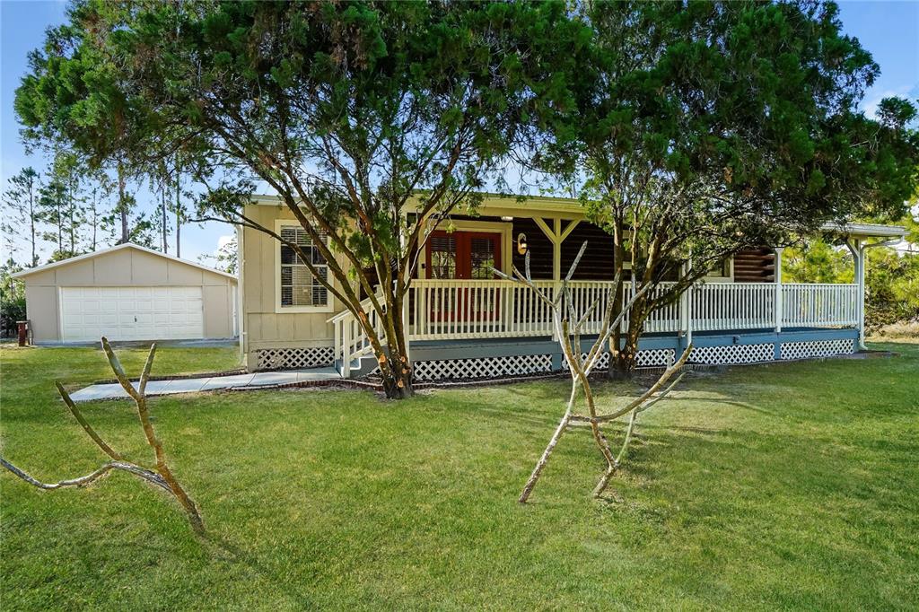 a view of a house with a backyard