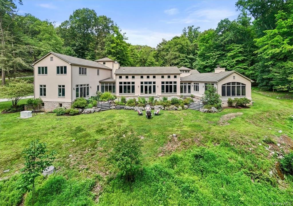 a front view of a house with a yard and green space