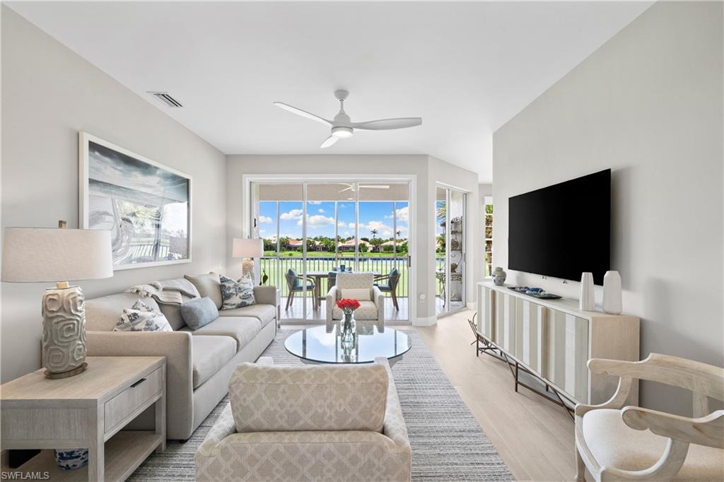 Living room with ceiling fan and light hardwood / wood-style floors