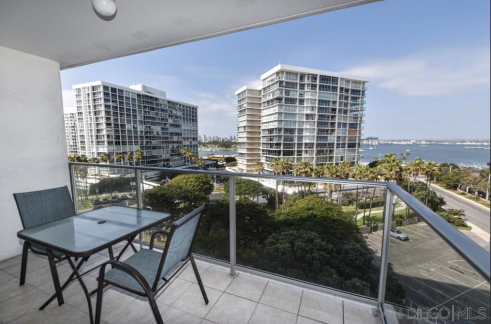 a balcony with table and chairs