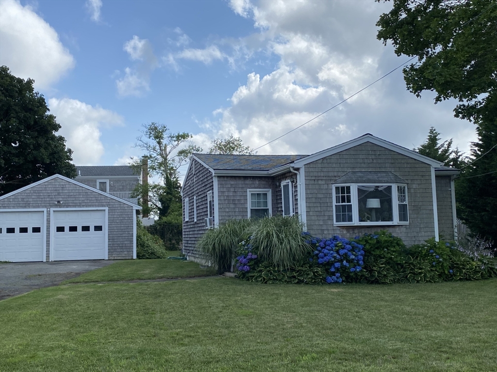 a front view of house with yard and green space