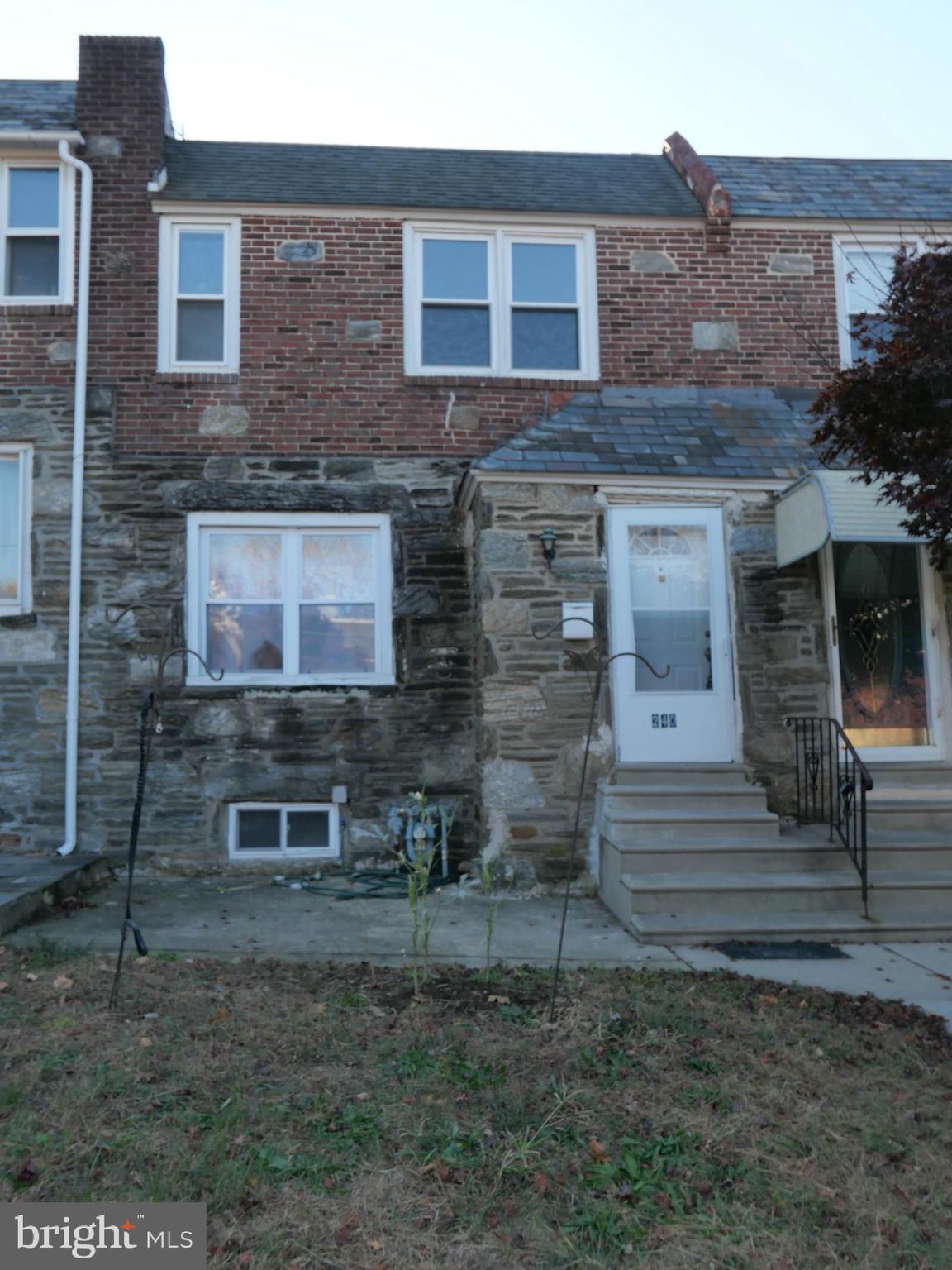 a brick building with a bench in front of it