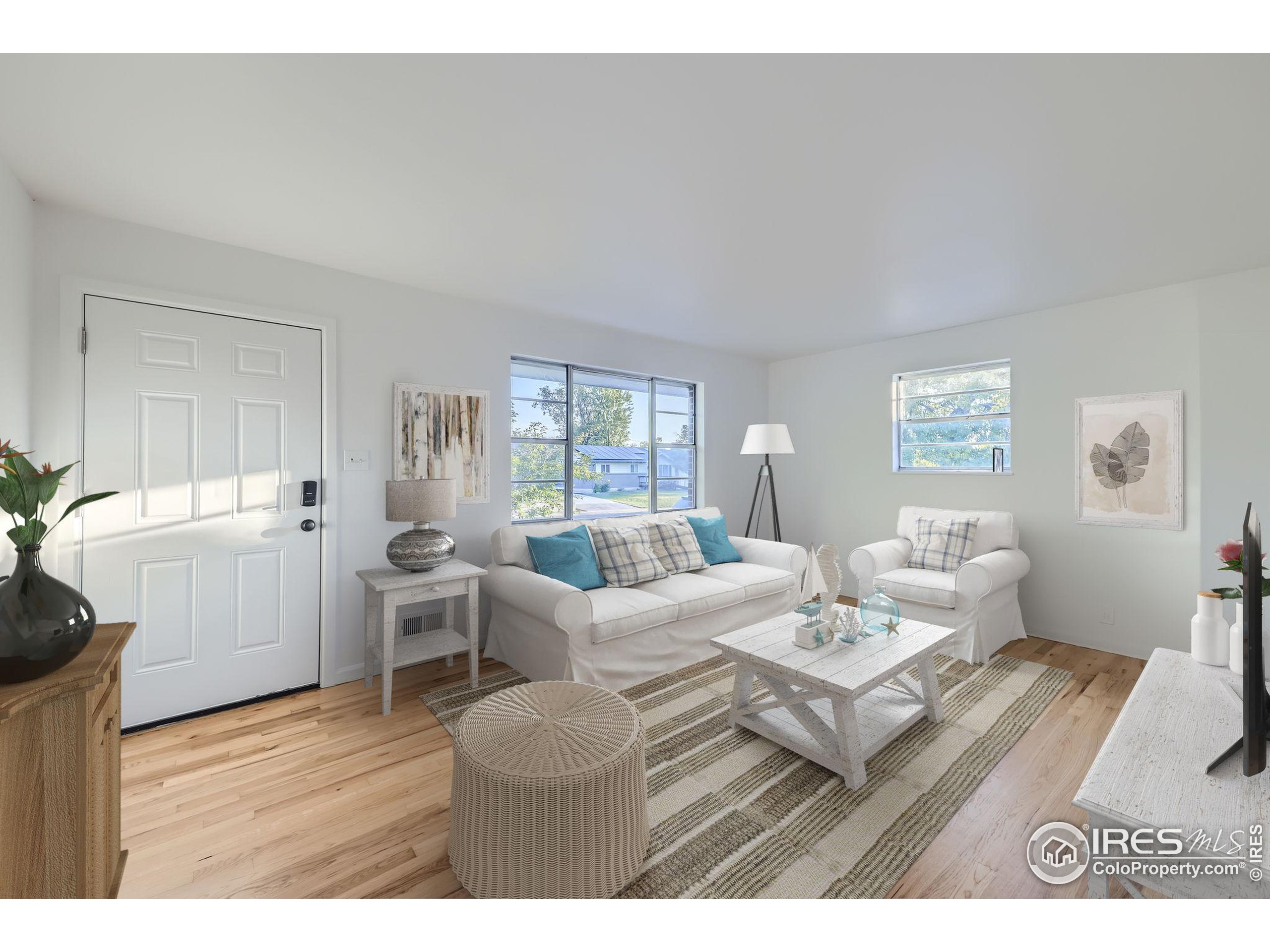 a living room with furniture a table and wooden floor