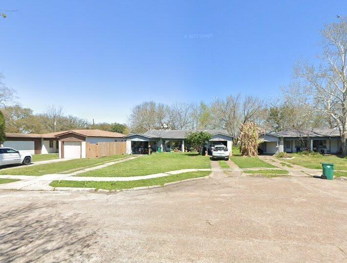 a front view of a house with a yard and trees