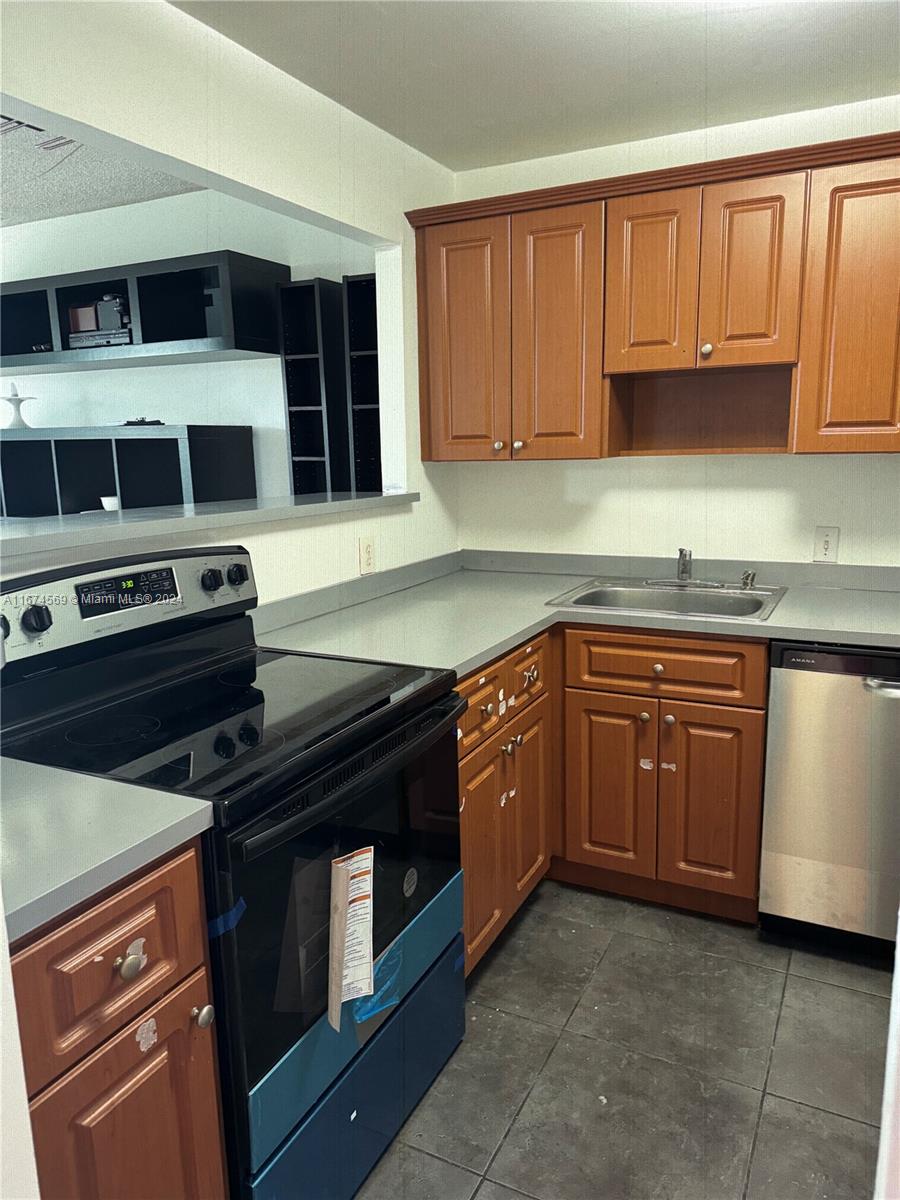 a kitchen with a stove microwave and cabinets