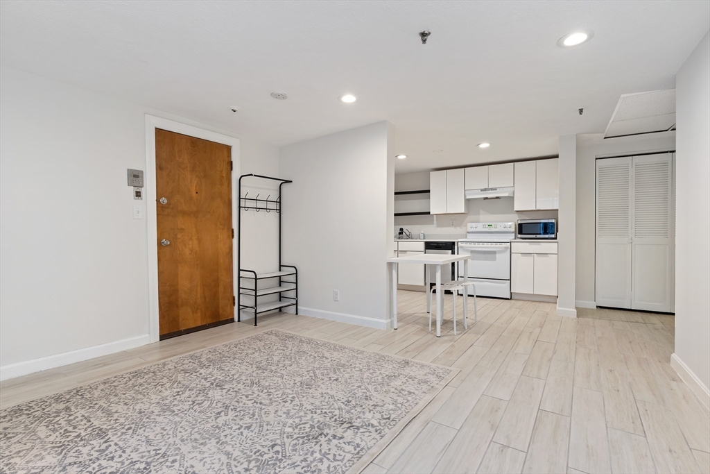 a view of kitchen with wooden floor and electronic appliances