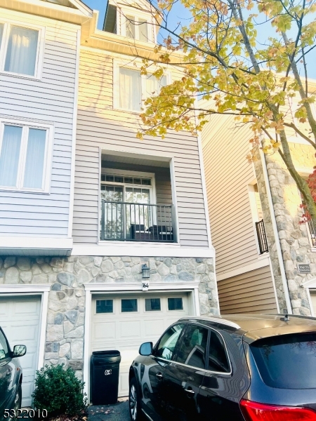 a front view of a house with parking space