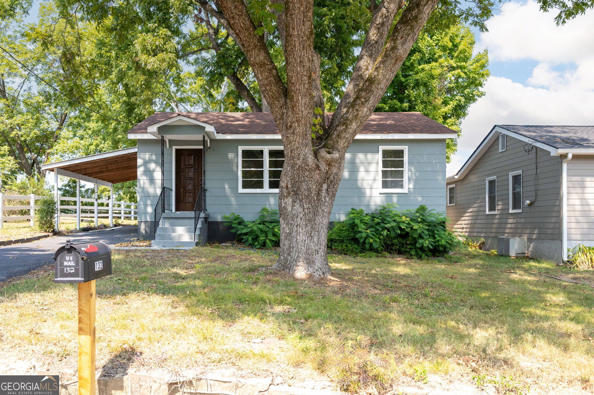 a front view of house with yard and green space