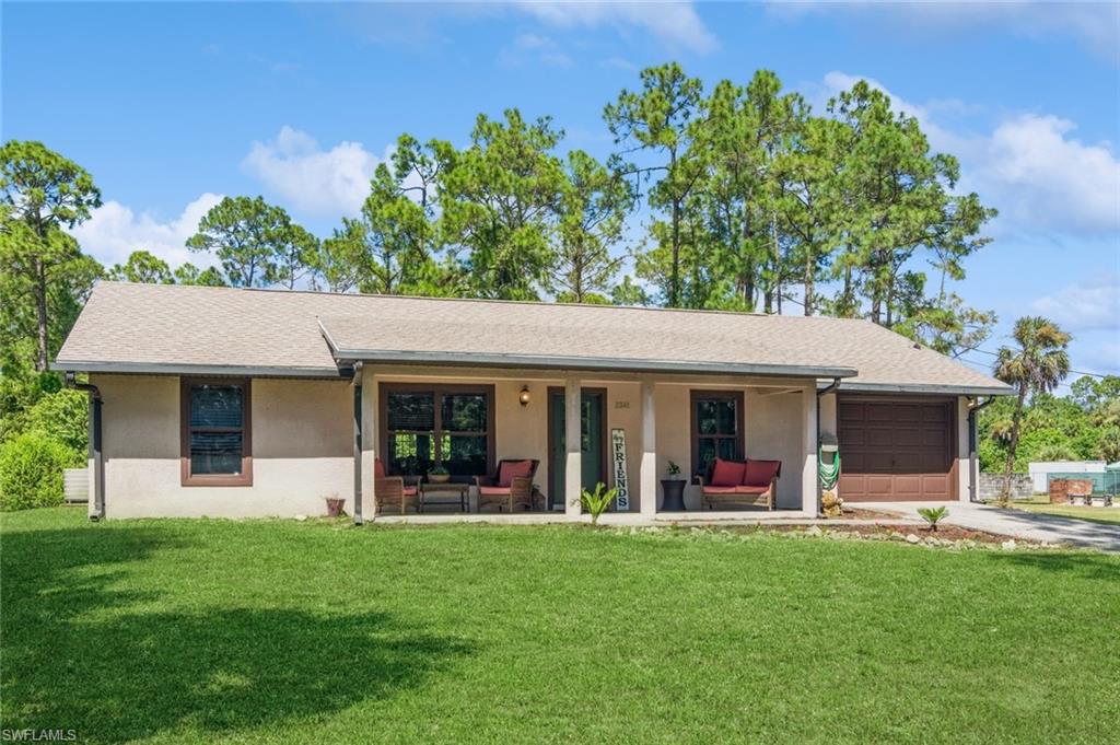 a view of a house with a backyard and porch