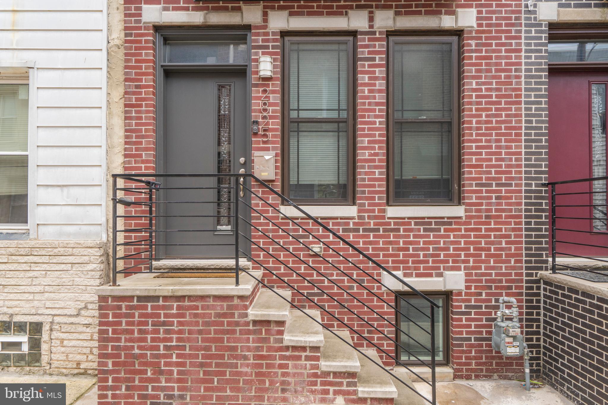 a brick house with a window and a door