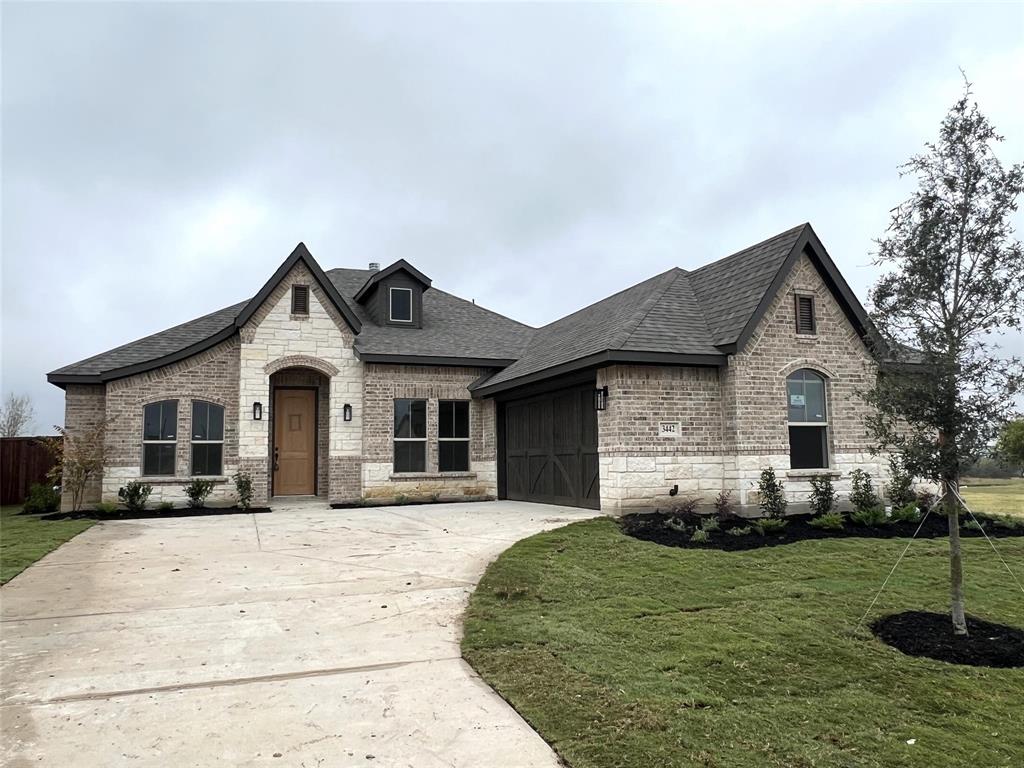 a front view of a house with a yard and garage