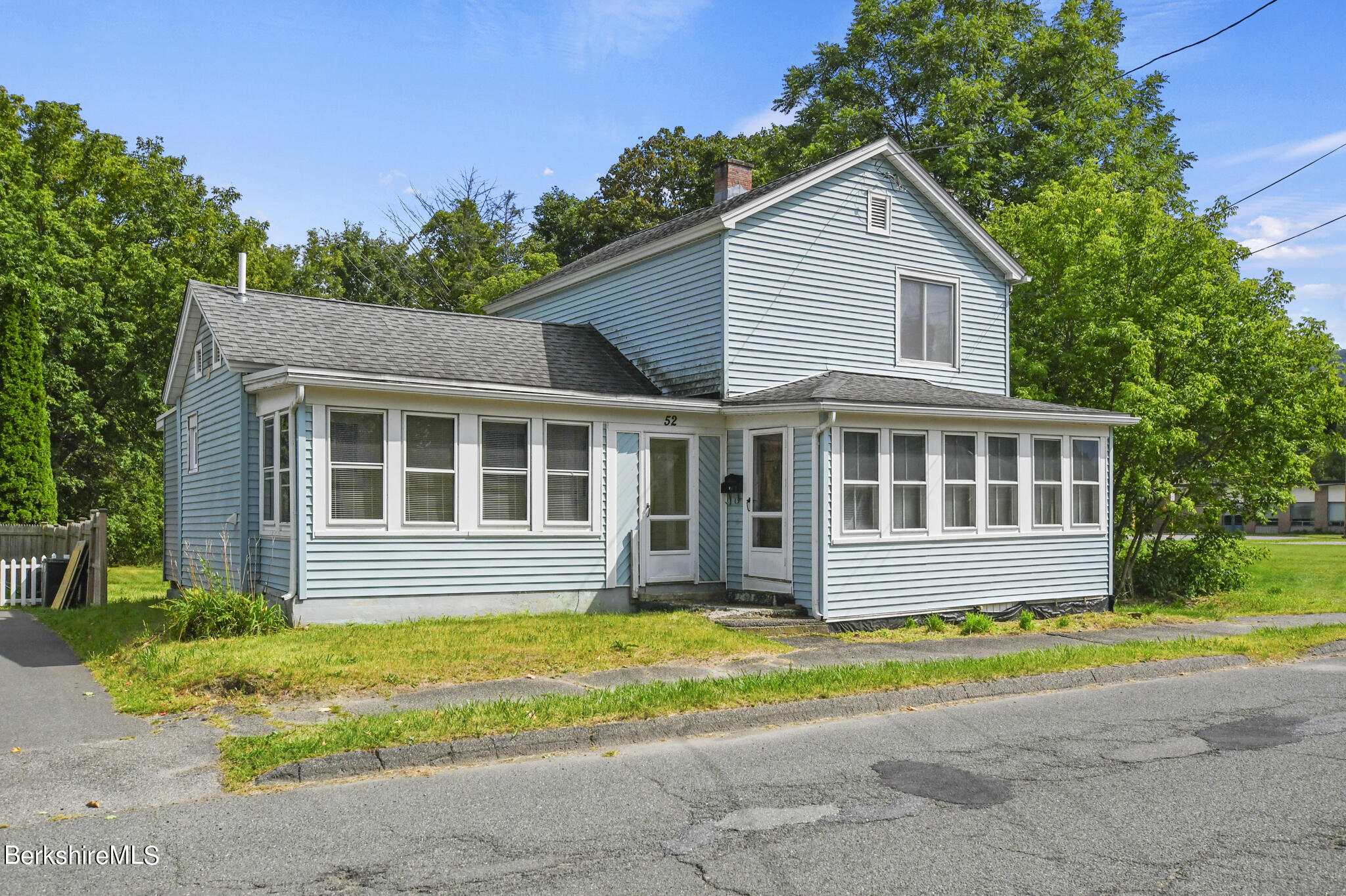 a front view of a house with a yard and outdoor seating