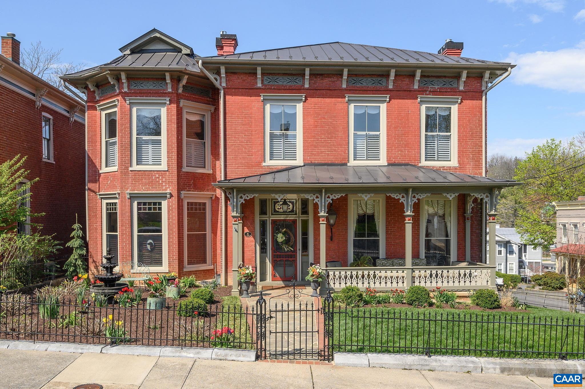 front view of a brick house with a small yard