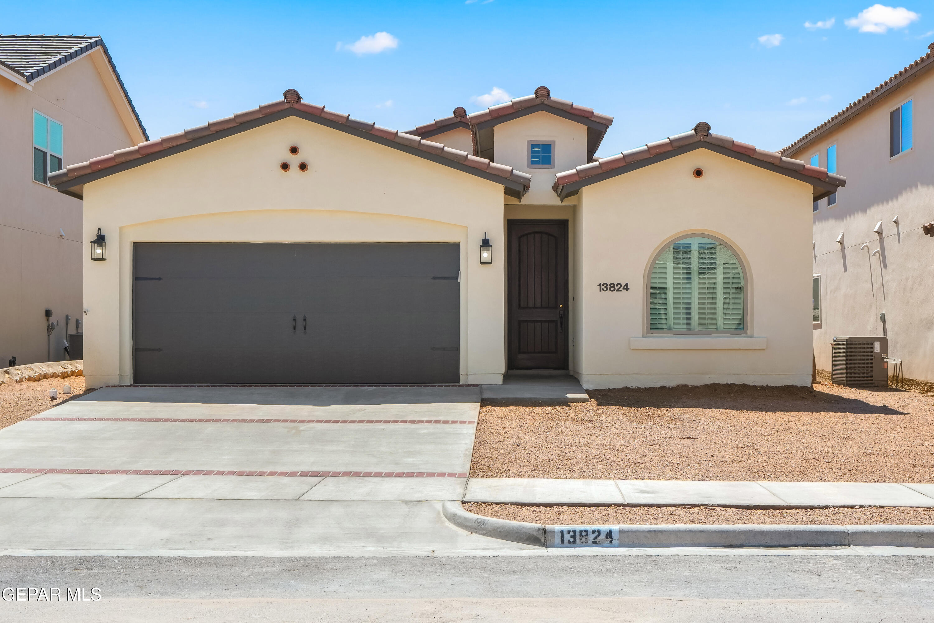 a front view of a house with garage