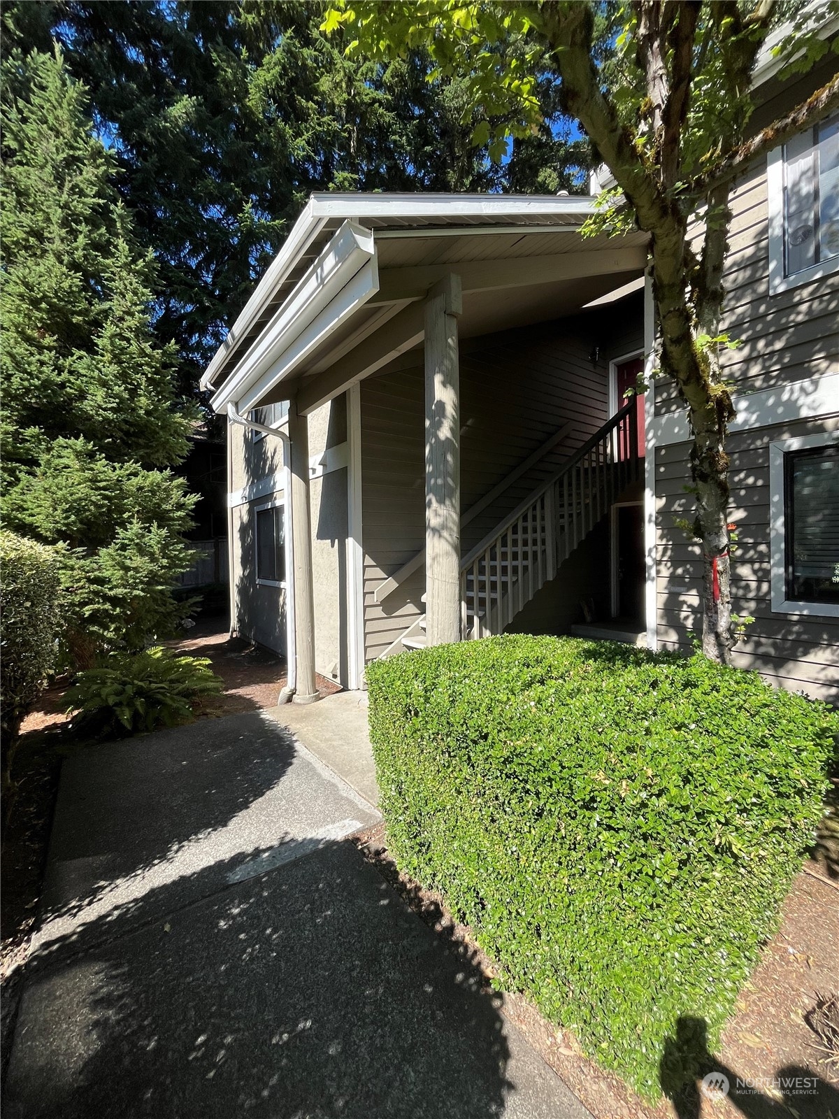 a front view of house with a garden