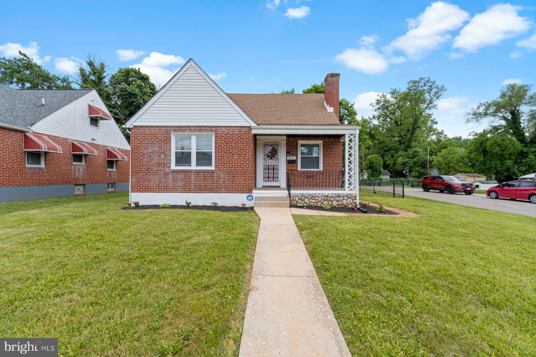 a front view of house with yard and green space