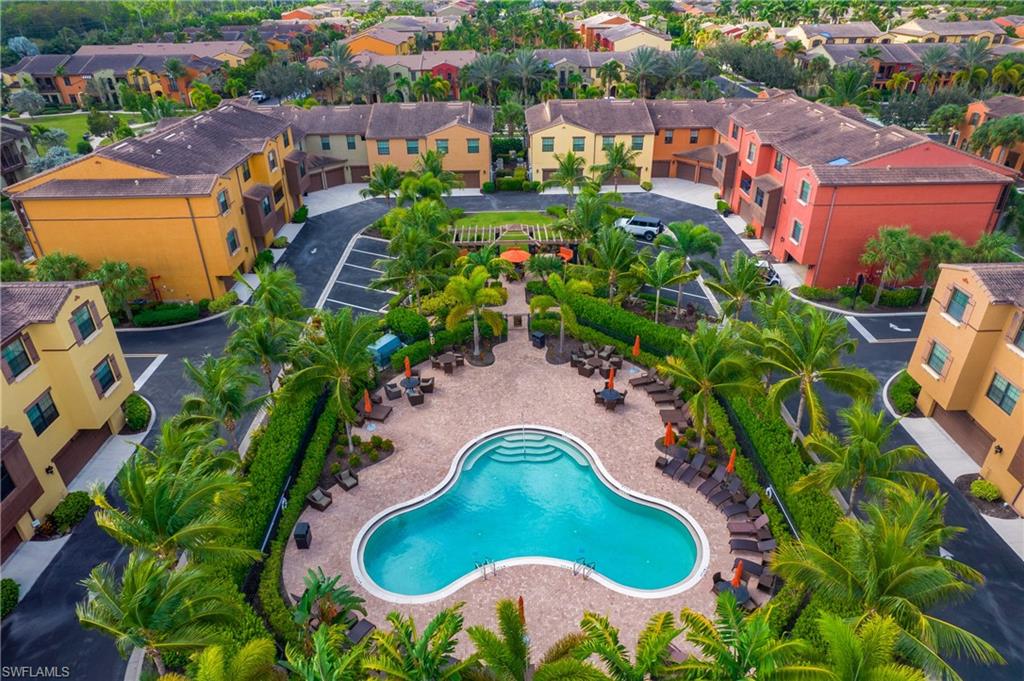 an aerial view of residential houses with outdoor space and swimming pool