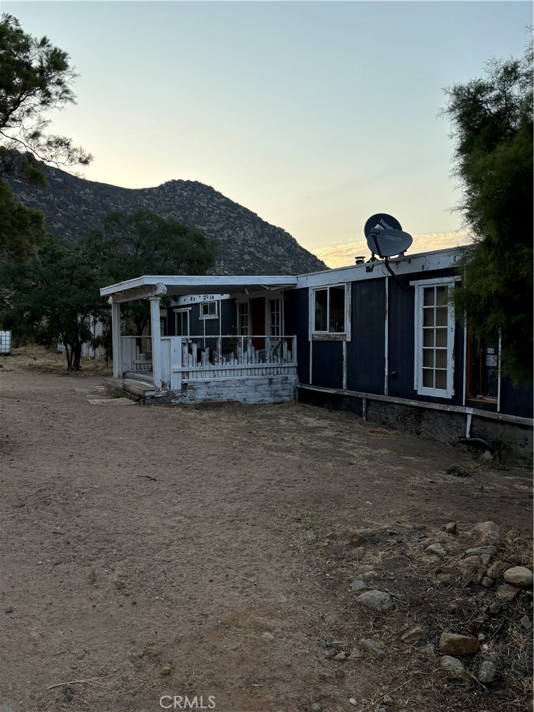 a front view of a house with a yard and potted plants