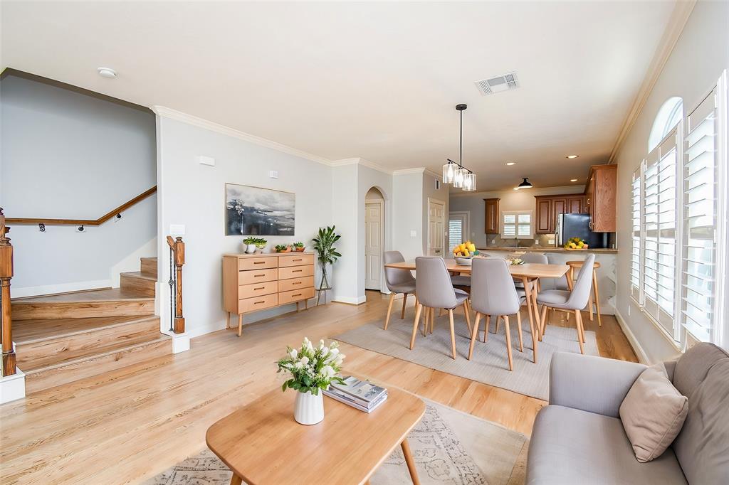 a living room with furniture kitchen and a chandelier