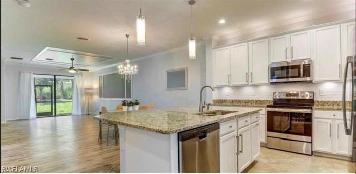 a kitchen with stainless steel appliances granite countertop a sink stove and cabinets