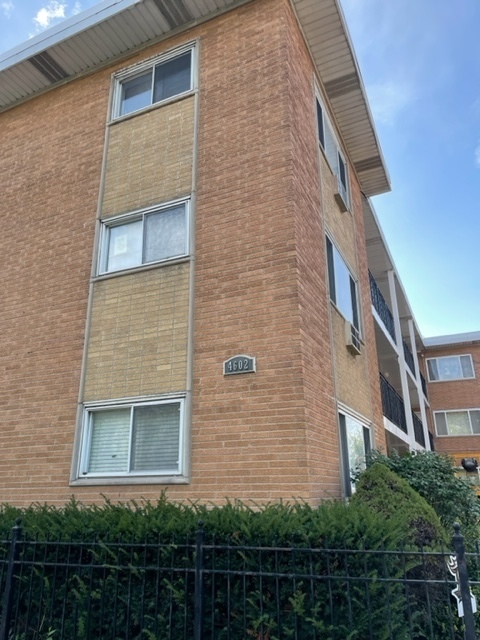 a brick building with a yard