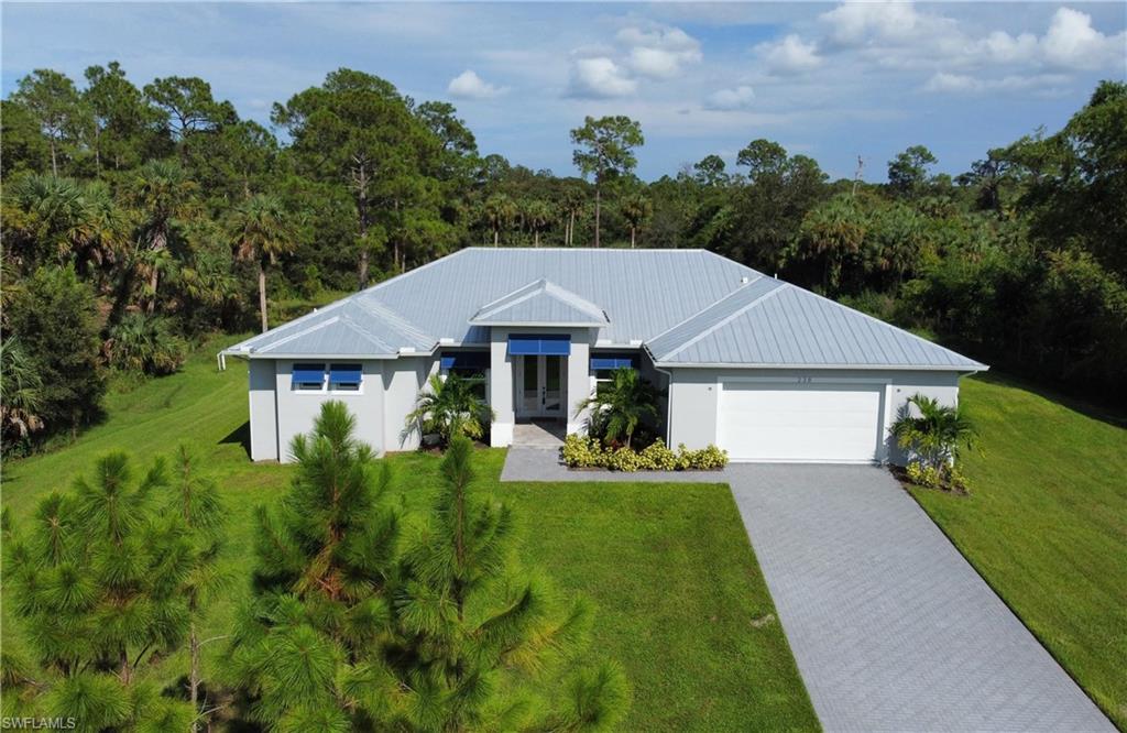 View of front of house with a front yard and a garage