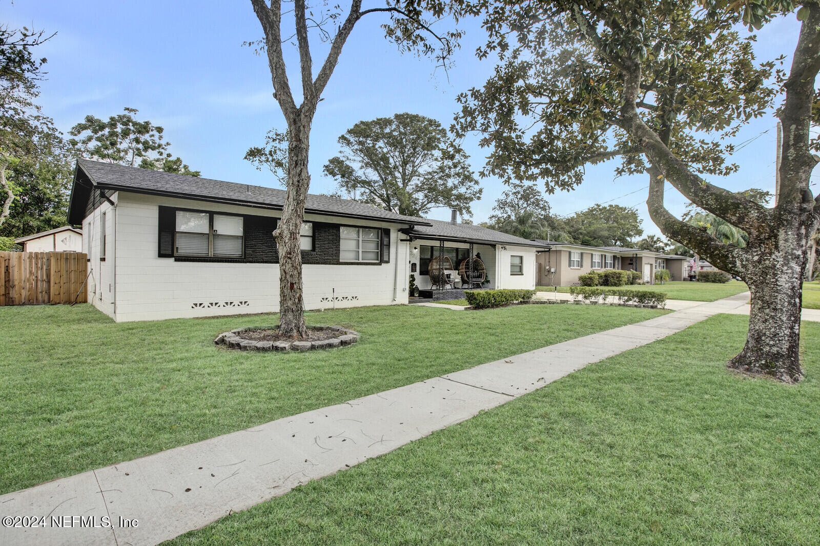 a front view of house with yard and green space