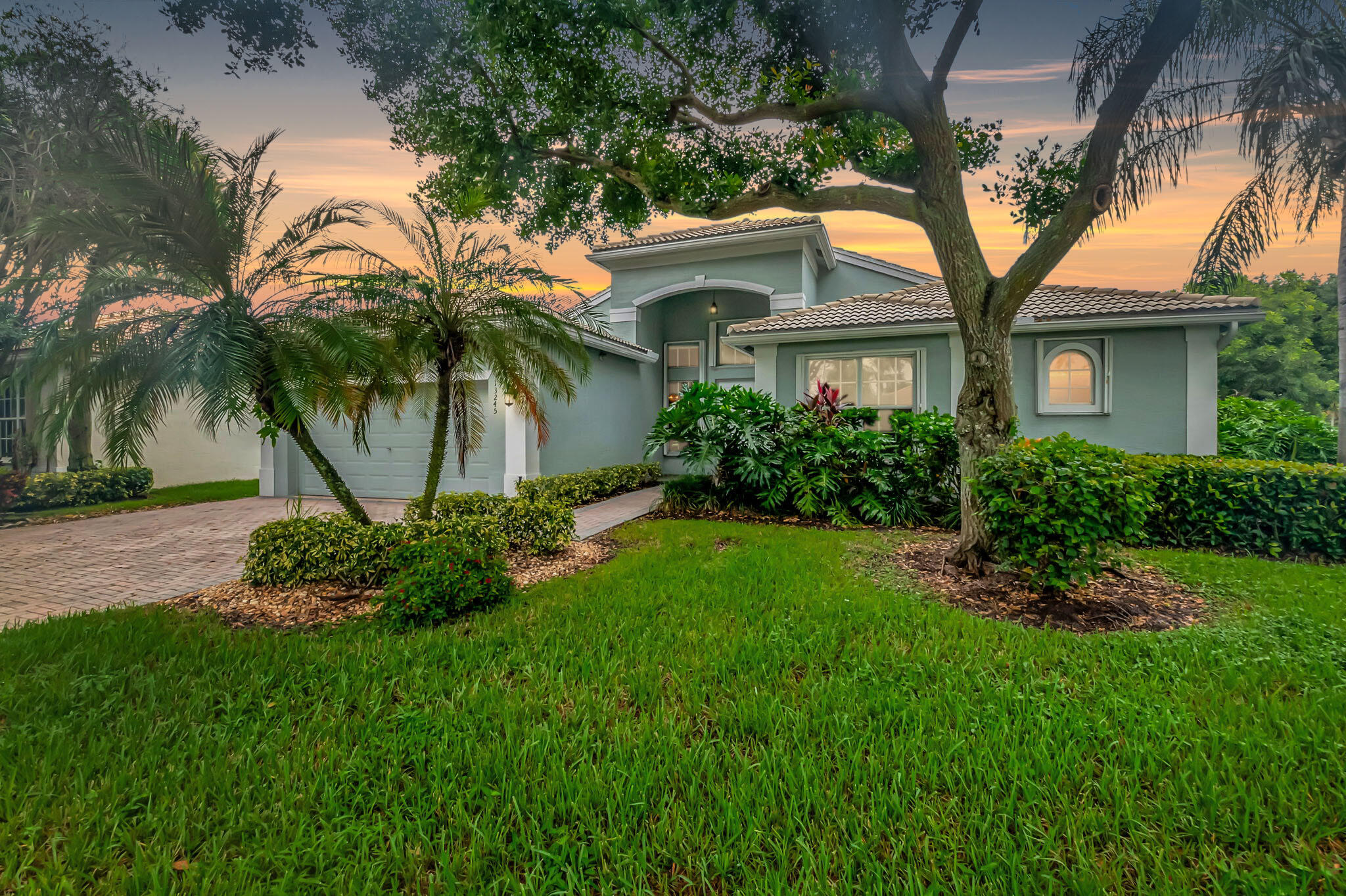 a front view of a house with a garden