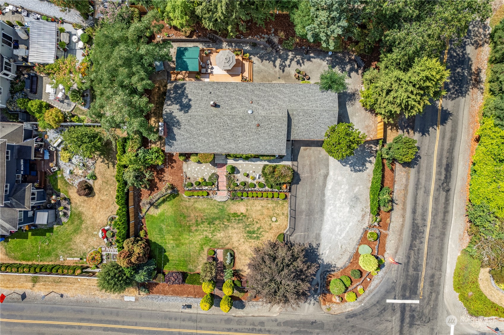 an aerial view of a house with a yard basket ball court and outdoor seating