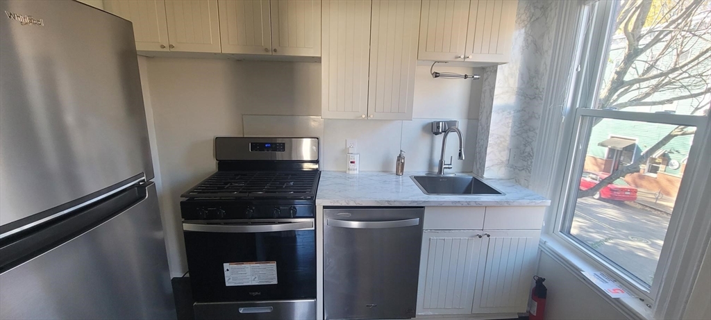 a kitchen with stainless steel appliances granite countertop a stove and a refrigerator