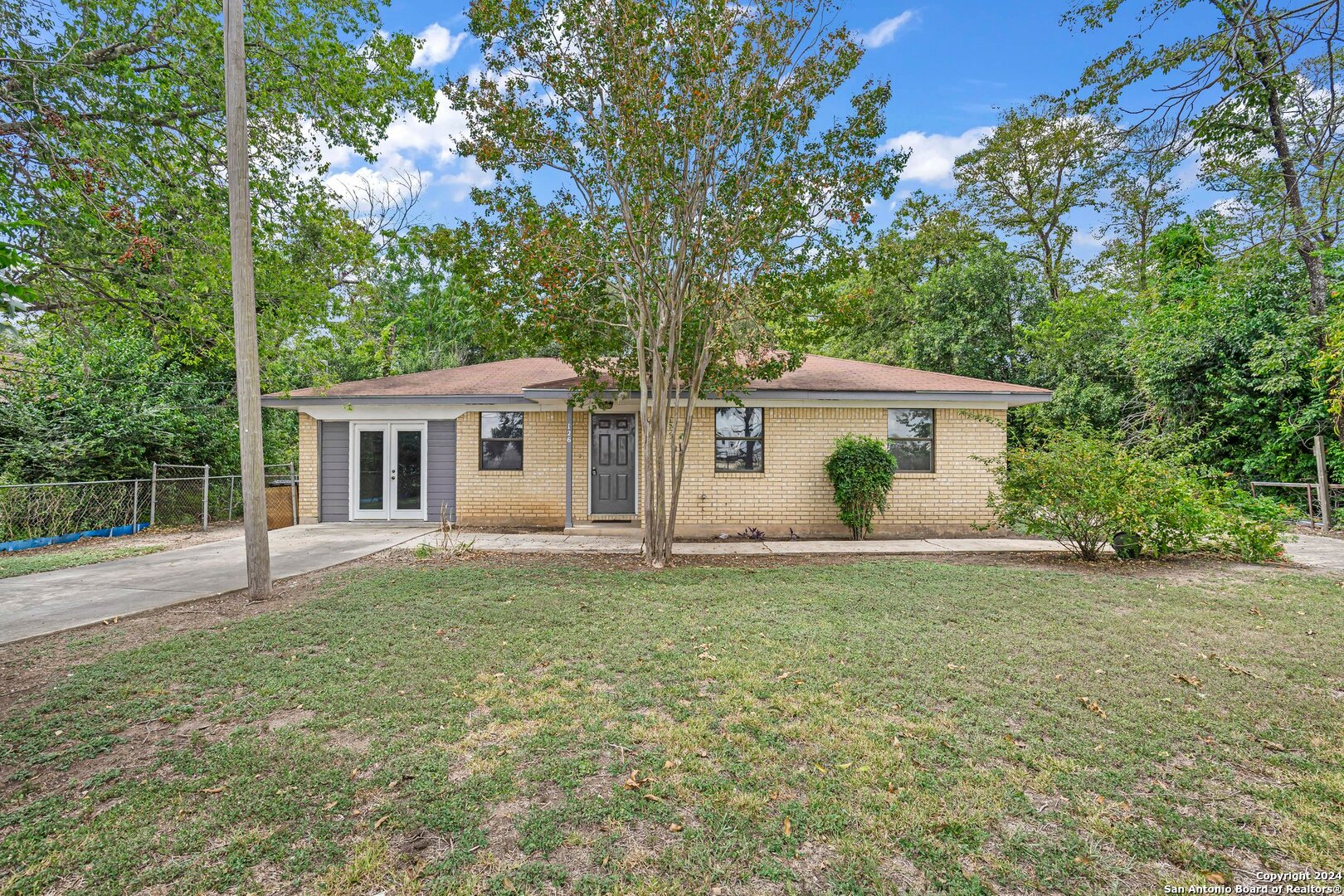 a front view of house with yard and green space