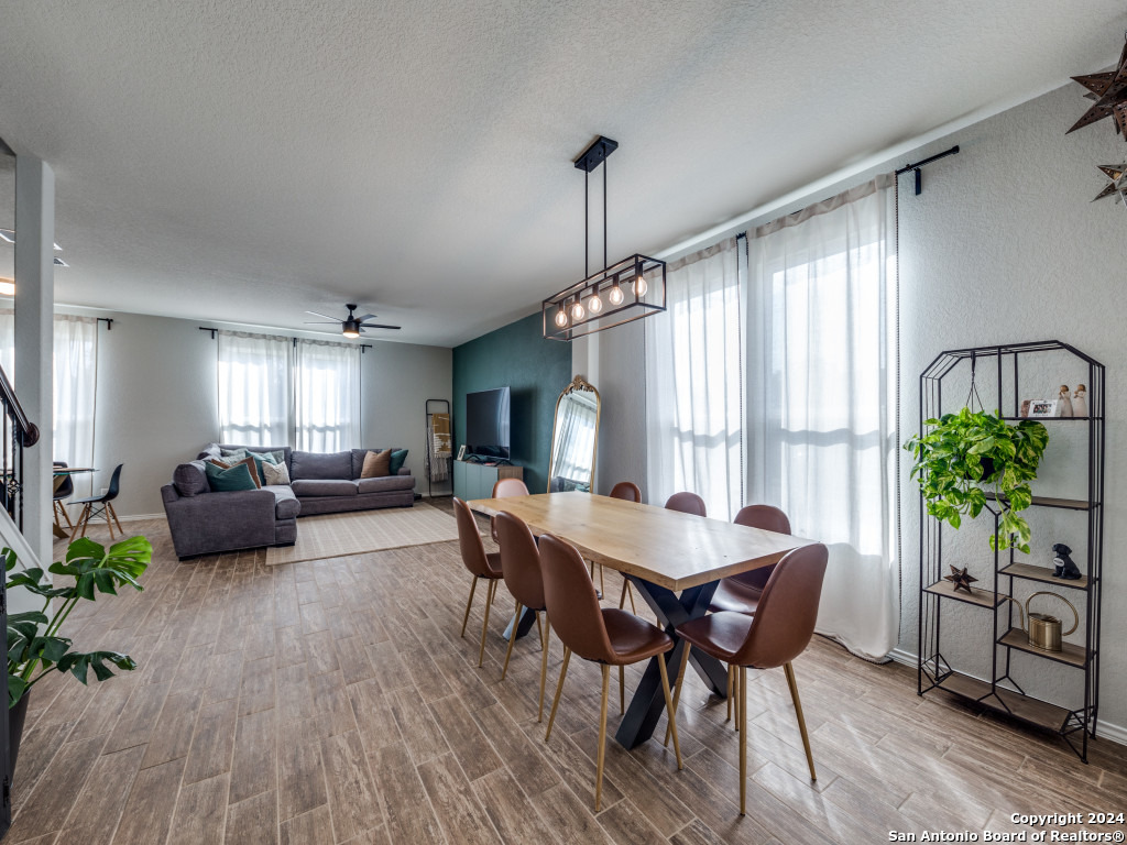 a view of a dining room with furniture window and wooden floor