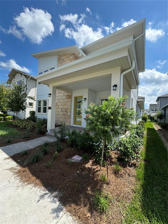 a view of a house with a yard and plants