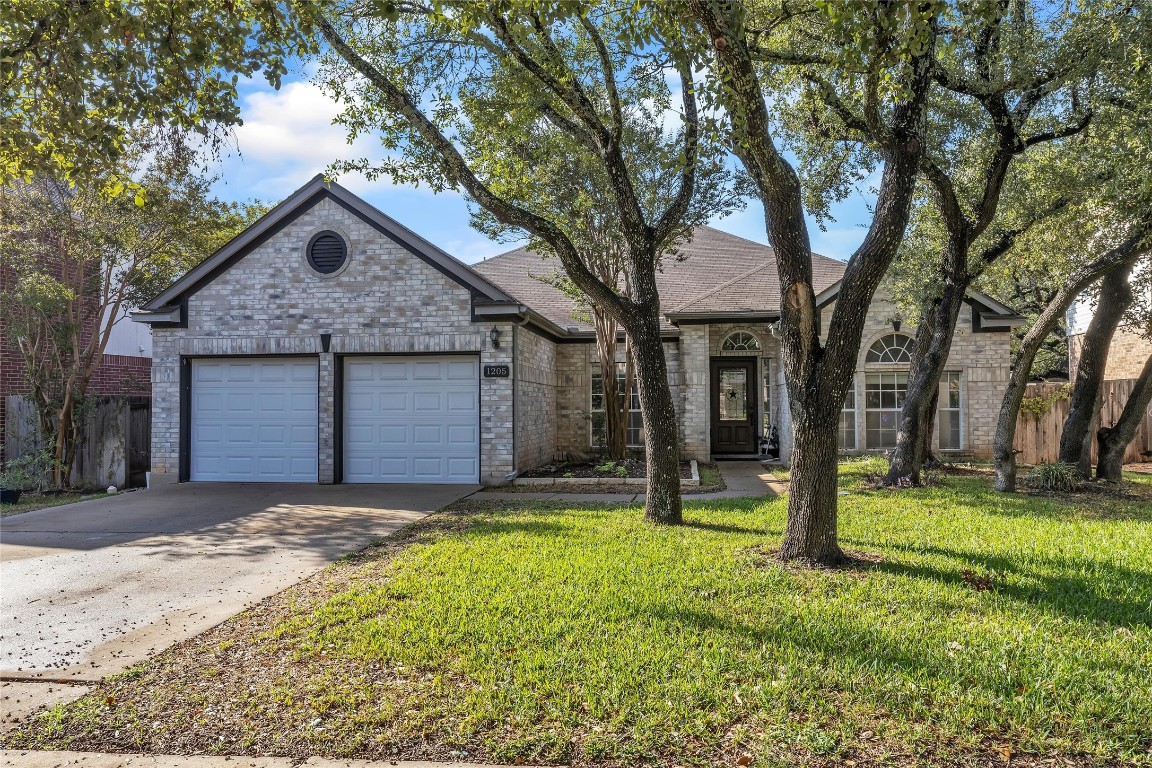 a view of a house with a yard and tree